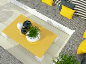 Outdoor patio seating area with big sofa and table.